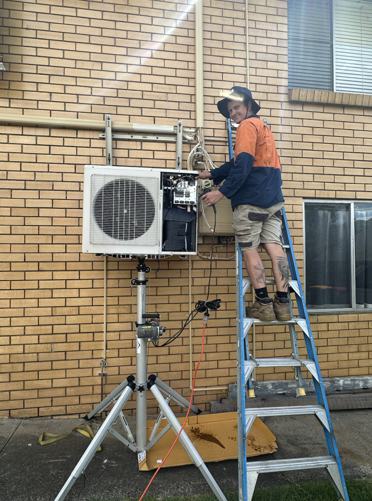 KTM Solutions Electrician fixing an AC